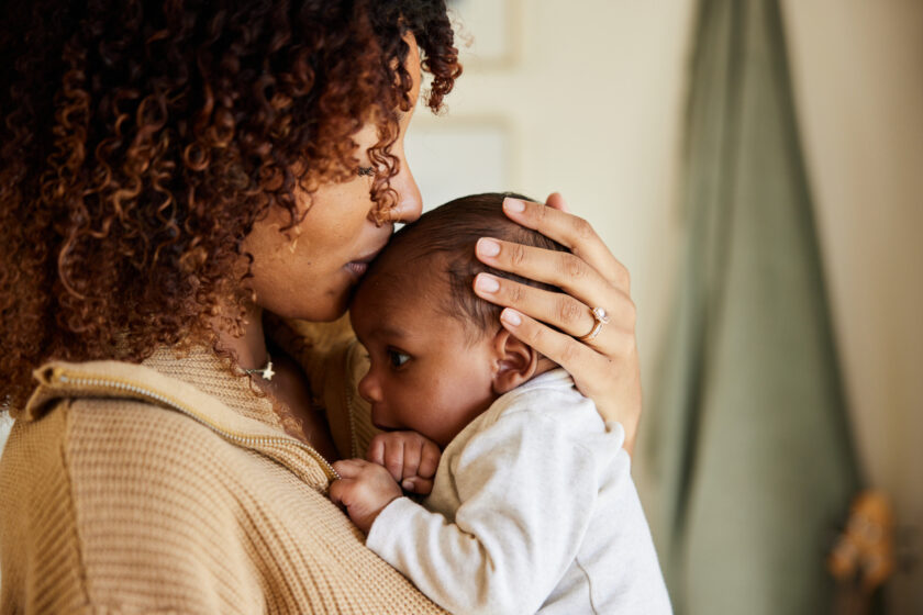 mother kissing babies forehead.