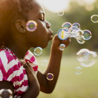 A child blowing bubbles.